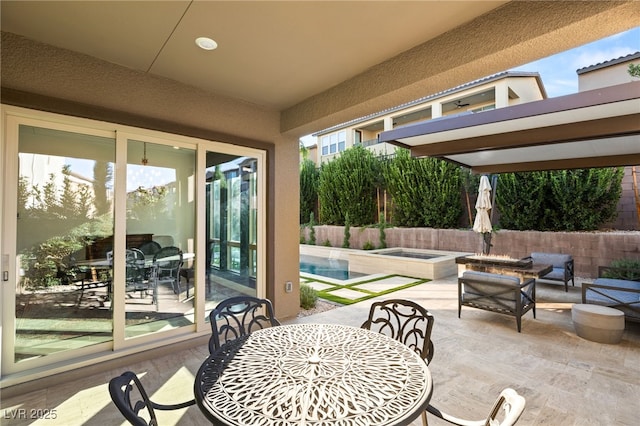 view of patio / terrace featuring a fenced in pool and an outdoor fire pit