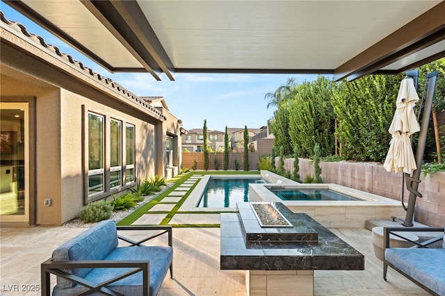 view of pool with a fire pit, a patio, and an in ground hot tub