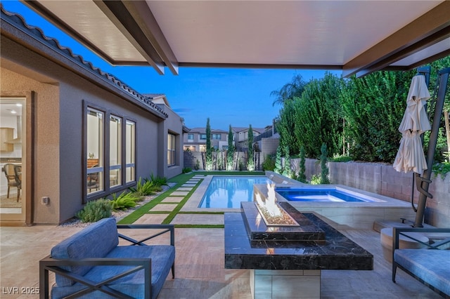 view of pool with an in ground hot tub, an outdoor fire pit, and a patio area