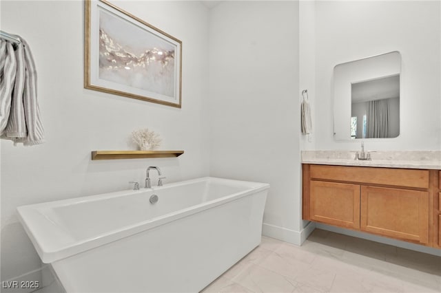 bathroom with vanity and a bath