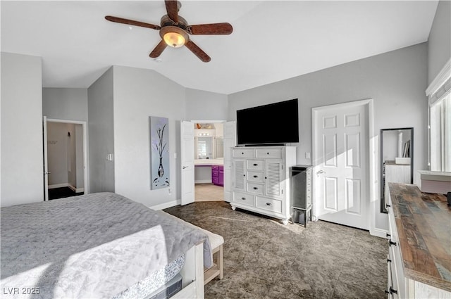 bedroom featuring lofted ceiling, ensuite bath, and ceiling fan