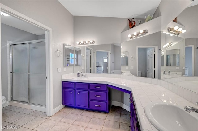 bathroom featuring vanity, tile patterned floors, a shower with door, and toilet