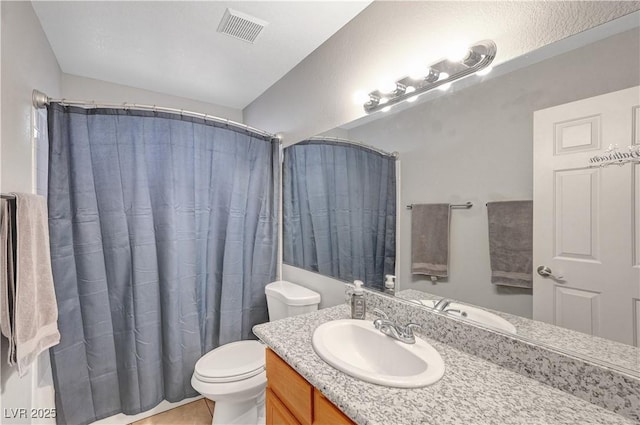 bathroom featuring vanity, walk in shower, and toilet