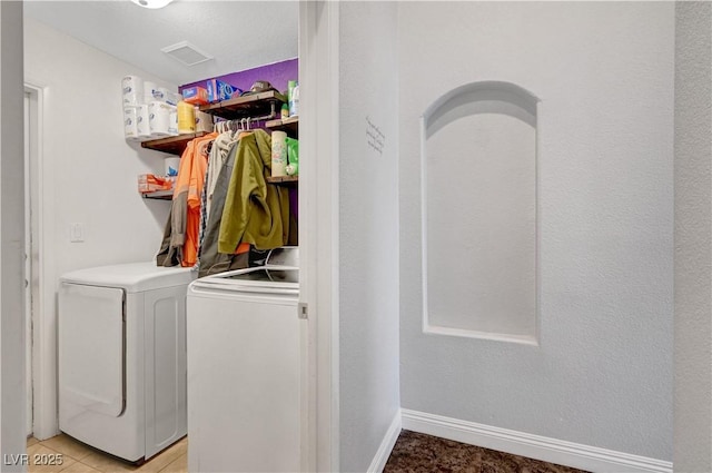 washroom with washer and dryer and light tile patterned floors