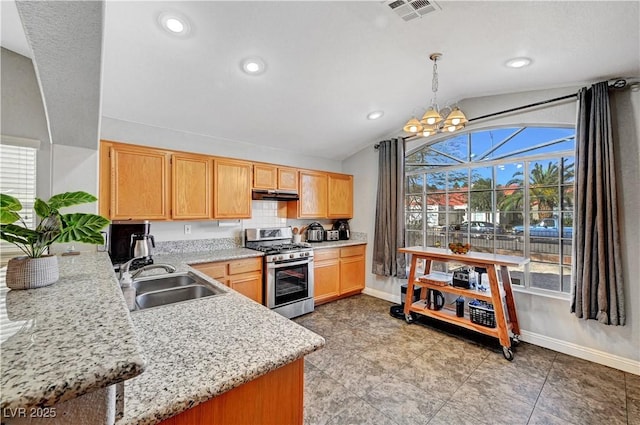 kitchen with sink, stainless steel gas range oven, vaulted ceiling, hanging light fixtures, and light stone countertops