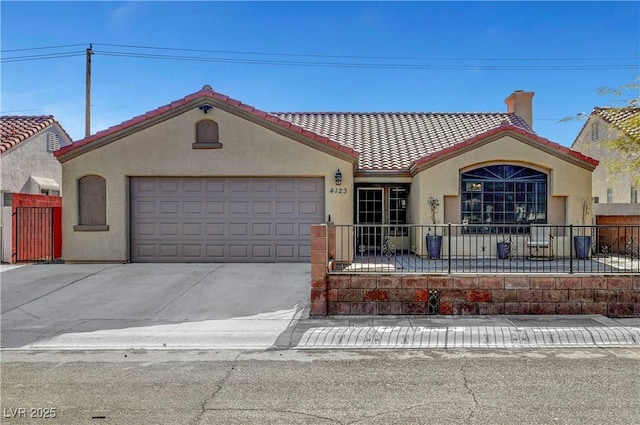 mediterranean / spanish home with a garage