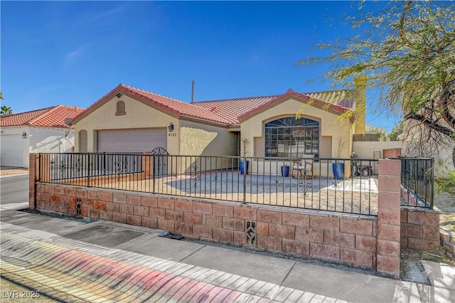 mediterranean / spanish-style home with a garage