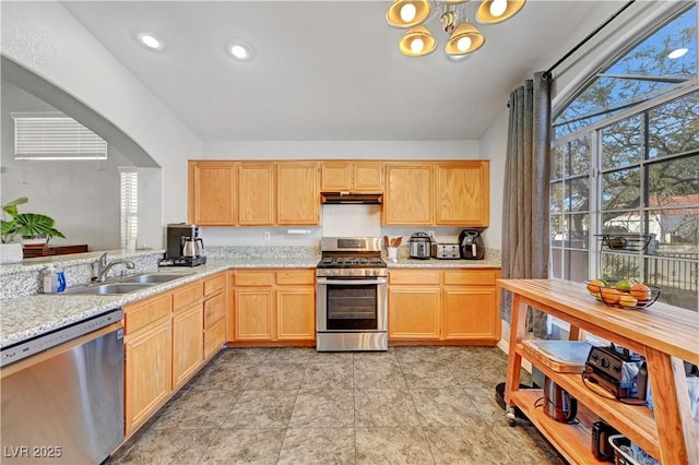 kitchen with an inviting chandelier, sink, light brown cabinets, and appliances with stainless steel finishes