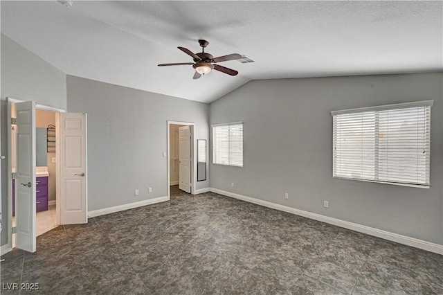 unfurnished bedroom with ceiling fan, a spacious closet, and vaulted ceiling