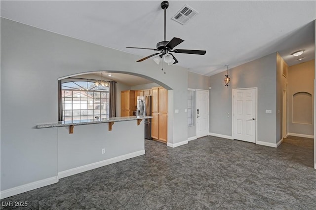 unfurnished living room featuring ceiling fan and lofted ceiling