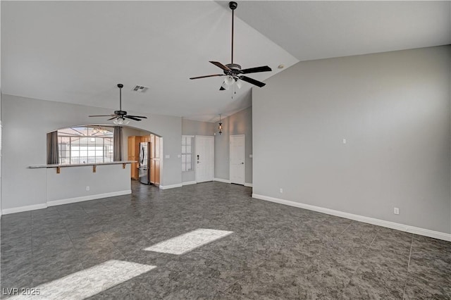 unfurnished living room featuring vaulted ceiling and ceiling fan