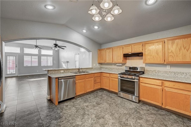 kitchen featuring decorative light fixtures, lofted ceiling, sink, kitchen peninsula, and stainless steel appliances