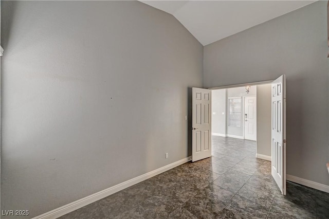 spare room with high vaulted ceiling