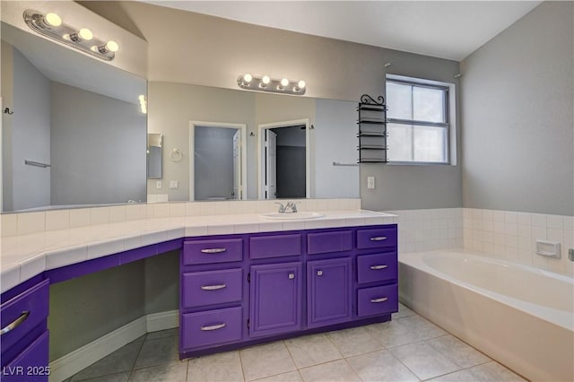 bathroom with vanity, tile patterned flooring, and a bathtub