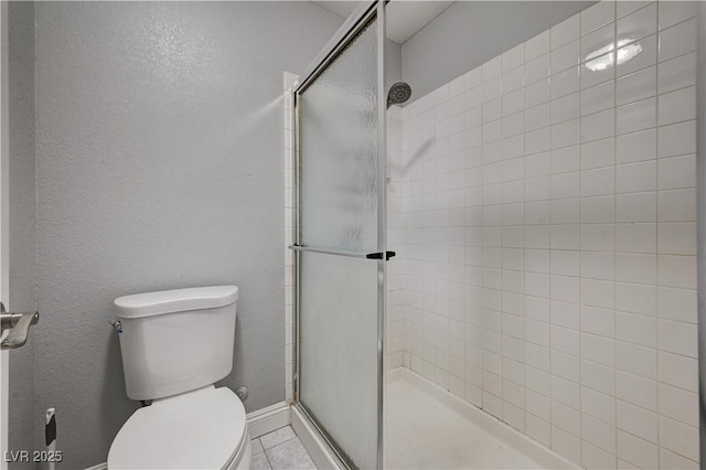 bathroom with a shower with door and toilet