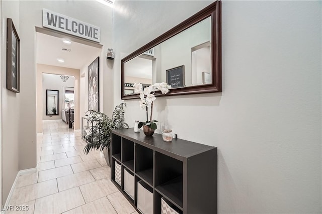 hallway featuring light tile patterned flooring