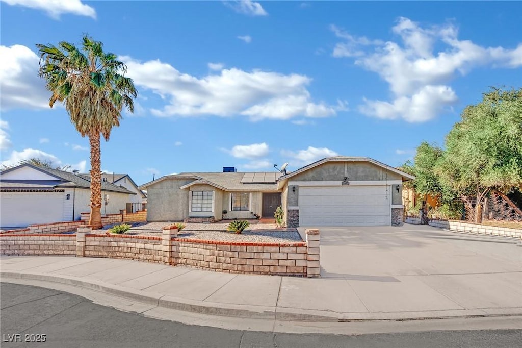 ranch-style house with solar panels and a garage