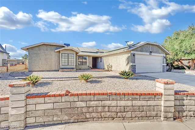 ranch-style home with solar panels and a garage