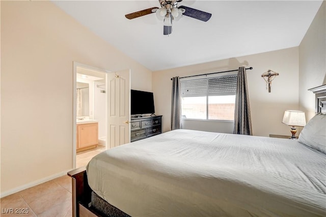 tiled bedroom featuring ceiling fan, lofted ceiling, and ensuite bath