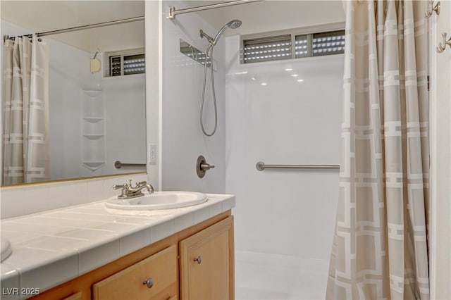 bathroom featuring curtained shower and vanity