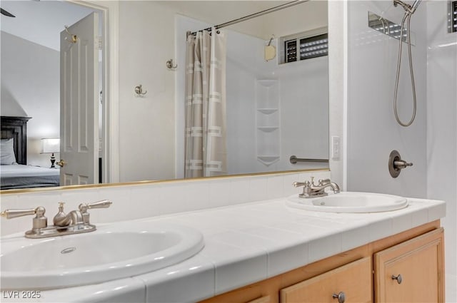 bathroom featuring a shower with shower curtain and vanity