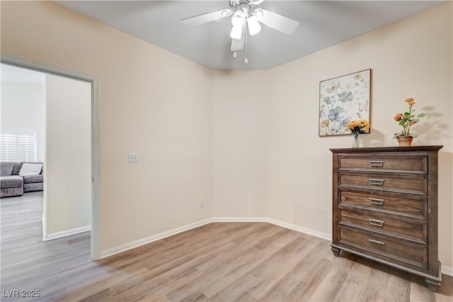 empty room featuring ceiling fan and light hardwood / wood-style flooring