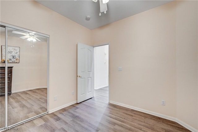 unfurnished bedroom featuring a closet, ceiling fan, and light hardwood / wood-style flooring