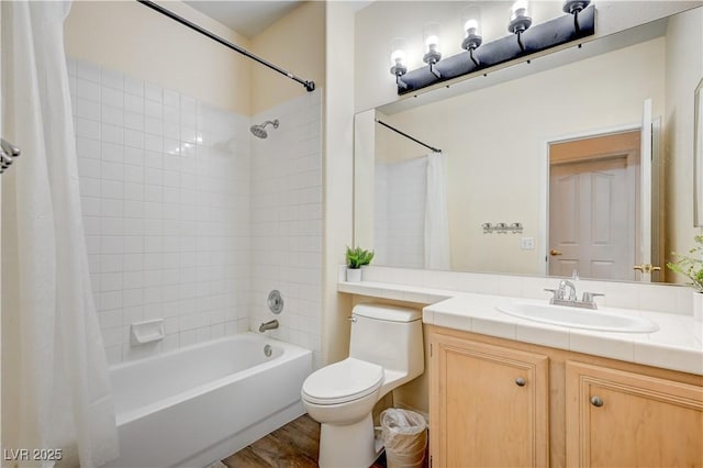 full bathroom with shower / bathtub combination with curtain, hardwood / wood-style floors, vanity, and toilet