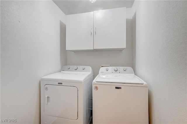 washroom with cabinets and independent washer and dryer