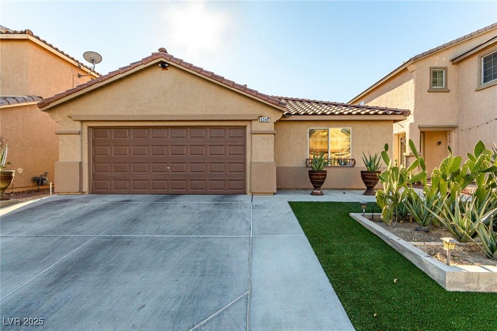 mediterranean / spanish-style home featuring a garage