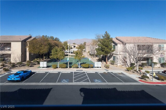 uncovered parking lot featuring a residential view