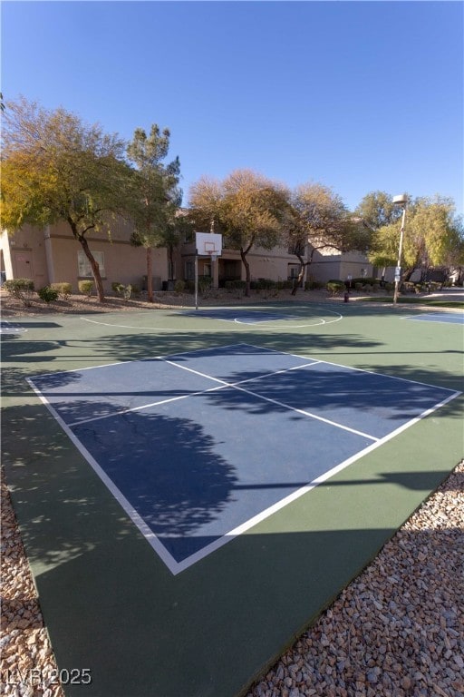 view of tennis court with community basketball court