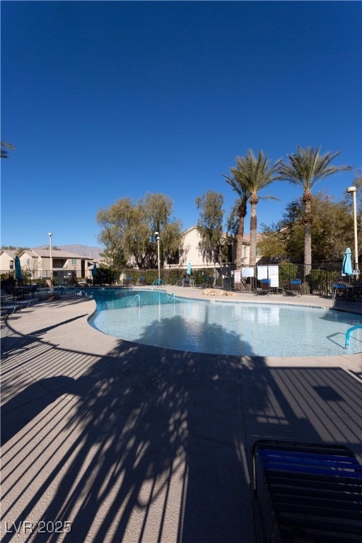 pool featuring a patio and fence