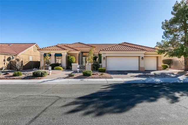 mediterranean / spanish home with a garage