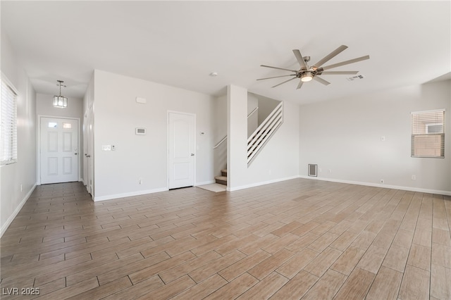 unfurnished living room featuring ceiling fan