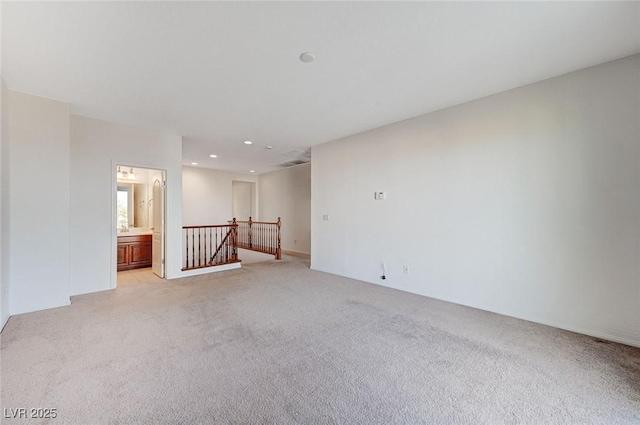 unfurnished room featuring recessed lighting and light colored carpet