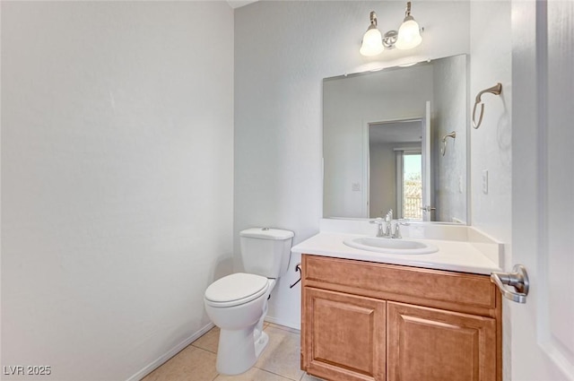 half bathroom featuring tile patterned flooring, vanity, and toilet