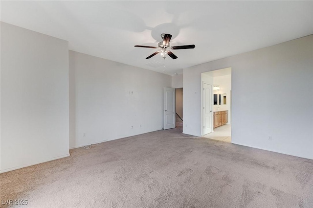 unfurnished bedroom with light carpet, ceiling fan, and ensuite bathroom