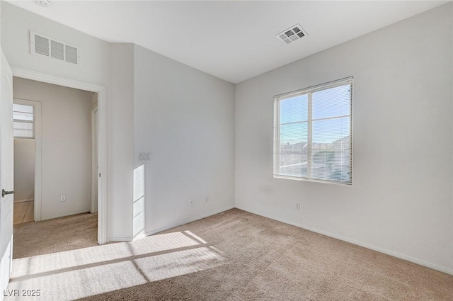 carpeted spare room with visible vents