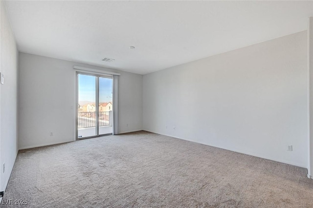 spare room with carpet floors and visible vents