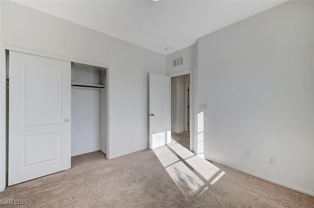 unfurnished bedroom with light carpet, a closet, and visible vents