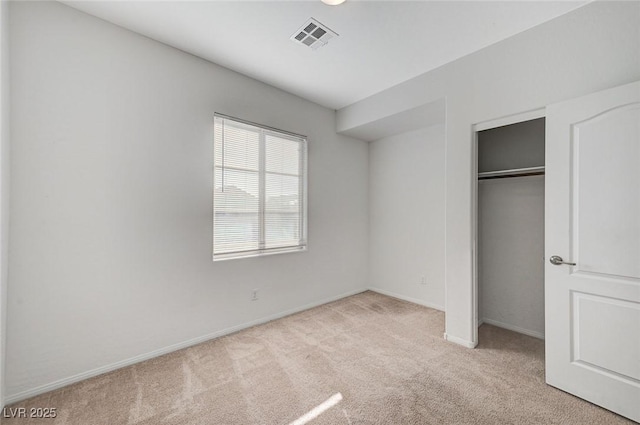 unfurnished bedroom featuring carpet floors, baseboards, visible vents, and a closet