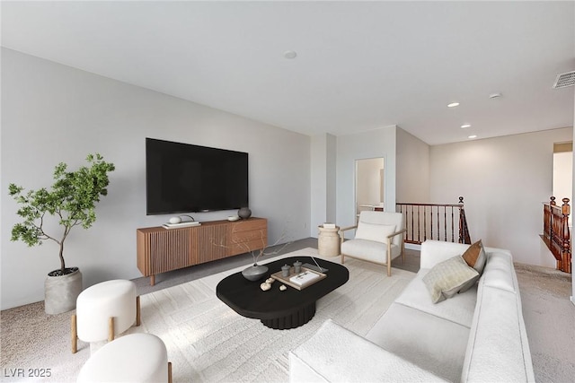 carpeted living room with visible vents and recessed lighting