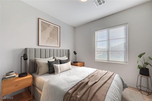 bedroom featuring carpet flooring, visible vents, and baseboards