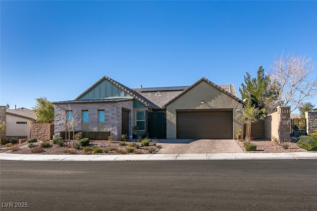 view of front of home with a garage and solar panels