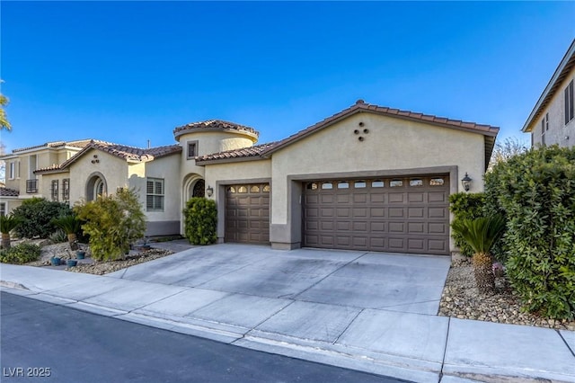 mediterranean / spanish-style house with a garage