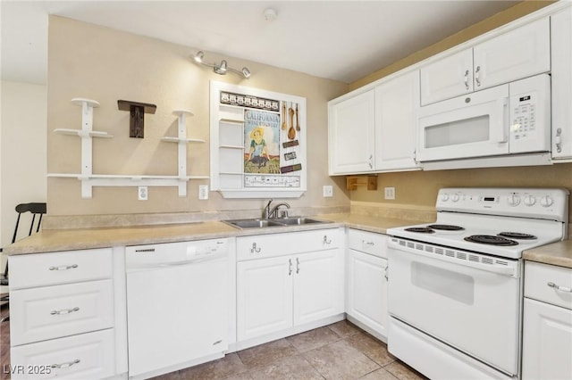 kitchen with sink, white cabinets, and white appliances