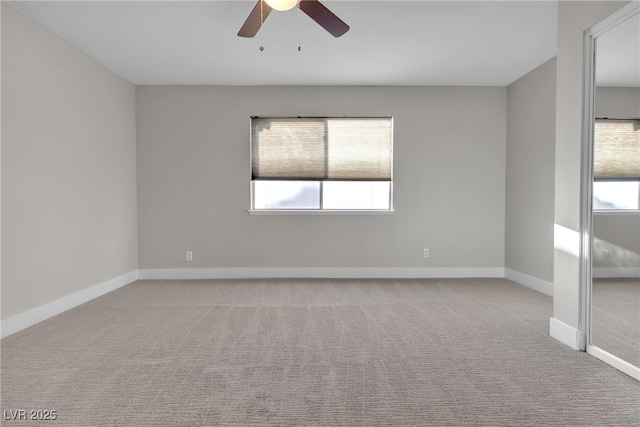 empty room with light colored carpet and ceiling fan