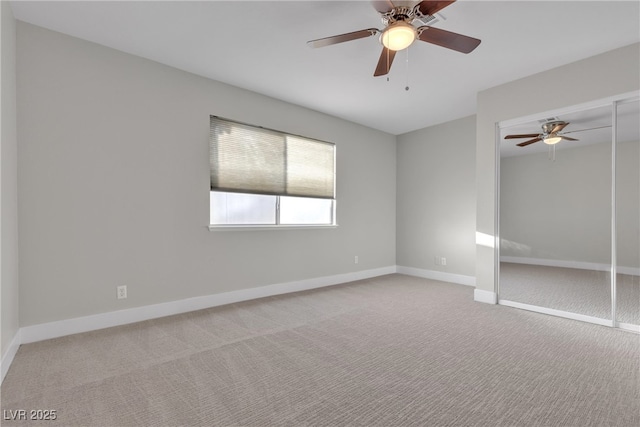 carpeted empty room featuring ceiling fan