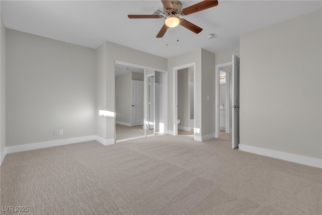 unfurnished bedroom with a closet, ceiling fan, and light colored carpet